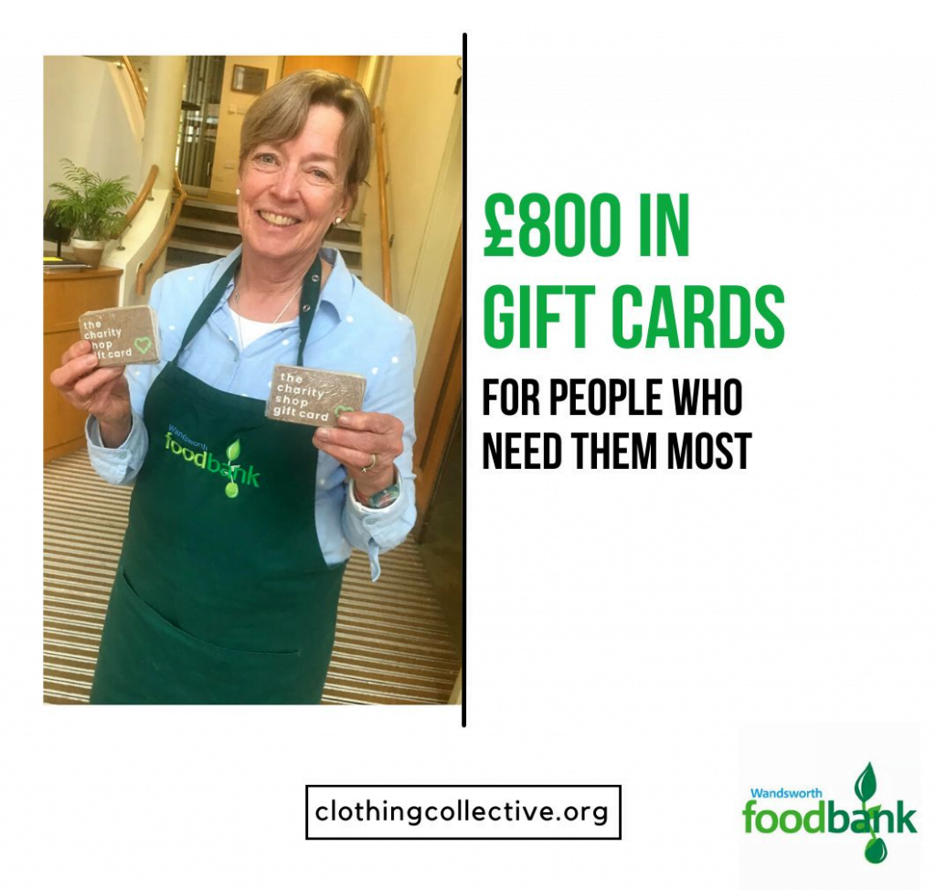 Person working for Wandsworth foodbank holding charity shop gift cards
