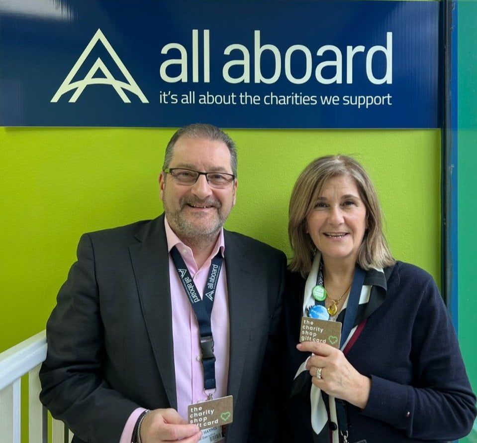 Alan Haynes, CEO and Danie Petrou, Head of Retail at All Aboard Charity Shops holding charity shop gift cards